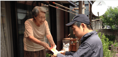 地域住民宅での作業後に ITSUMO利用者が報酬をいただく様子